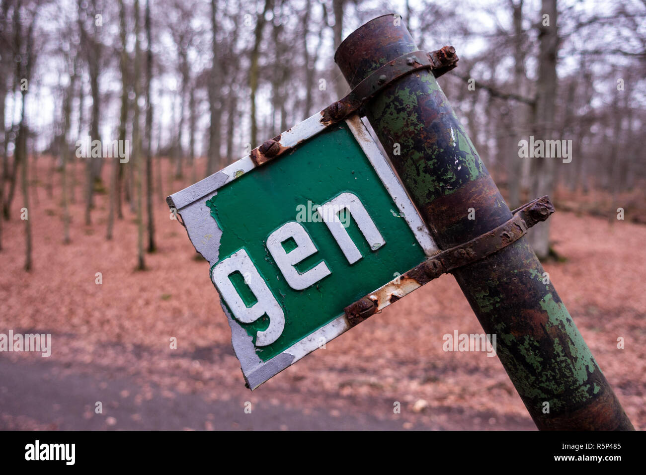 Broken and leaning rusty street sign Stock Photo