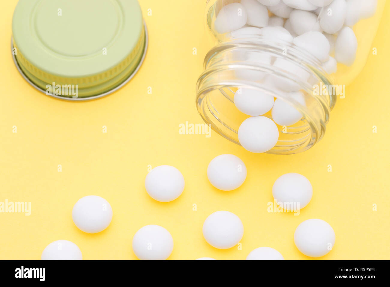 Download Glass Bottle And Pills On Light Yellow Background Stock Photo Alamy PSD Mockup Templates
