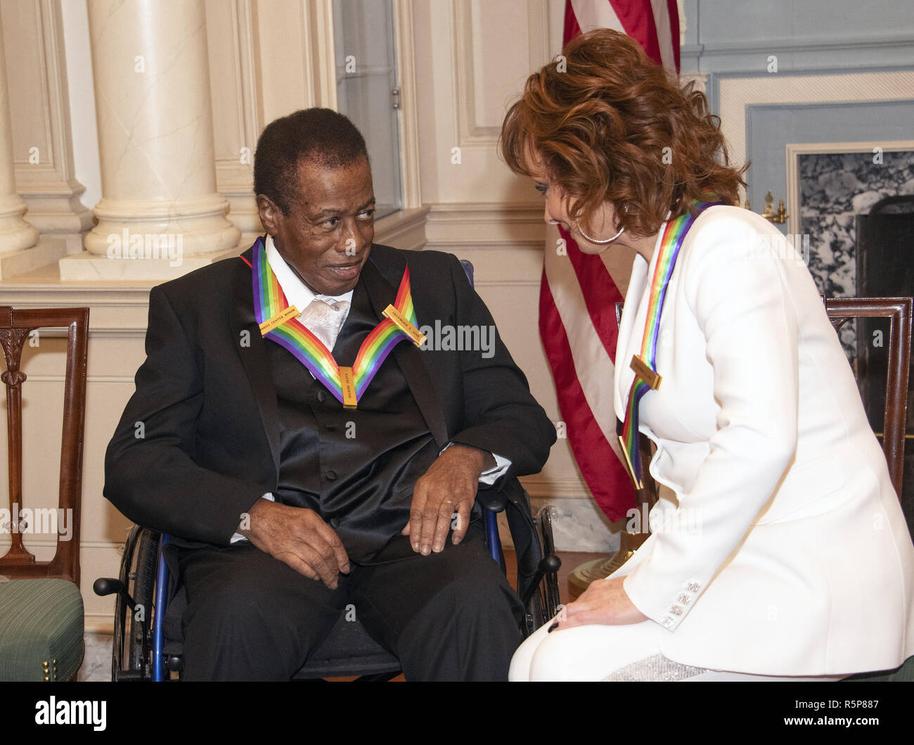 December 1, 2018 - Washington, District of Columbia, U.S. - Wayne Shorter, left and Reba McEntire, right, two of the recipients of the 41st Annual Kennedy Center Honors, converse prior to posing for a group photo following a dinner hosted by United States Deputy Secretary of State John J. Sullivan in their honor at the US Department of State in Washington, DC on Saturday, December 1, 2018. The 2018 honorees are: singer and actress Cher; composer and pianist Philip Glass; Country music entertainer Reba McEntire; and jazz saxophonist and composer Wayne Shorter. This year, the co-creators of H Stock Photo