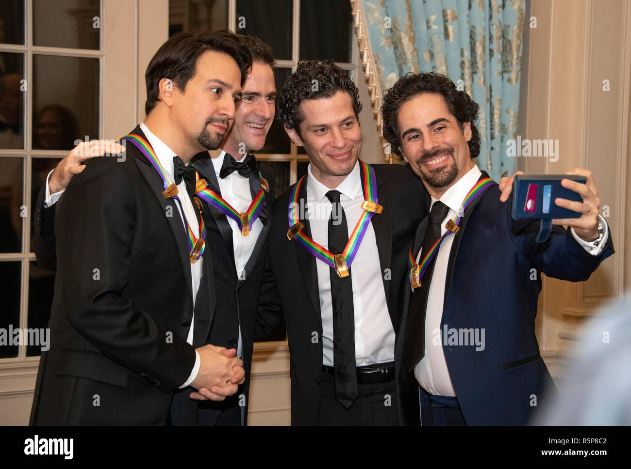 Hamilton co-creators Lin-manuel Miranda, Andy Blankenbuehler, Thomas Kail, and Alex Lacamoire, four of the recipients of the 41st Annual Kennedy Center Honors, pose for a selfie prior to sitting for a group photo following a dinner hosted by United States Deputy Secretary of State John J. Sullivan in their honor at the US Department of State in Washington, DC on Saturday, December 1, 2018. The 2018 honorees are: singer and actress Cher; composer and pianist Philip Glass; Country music entertainer Reba McEntire; and jazz saxophonist and composer Wayne Shorter. This year, the co-creators of H Stock Photo