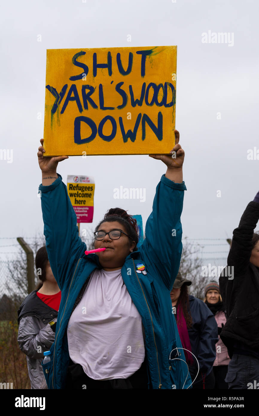 Milton Ernest, Bedford, UK. 1st December 2018. Yarls Wood Immigration Removal Centre ‘Suround Yarls Wood - Shut Down Yarls Wood and all Detention Centres’ demonstration. Hundreds braved the poor weather to join the protest at the remotely situated Yarls Wood IRC. Incarcerated women waved desperately at windows and their mobile phone conversations were relayed via the PA system outside the security fence. Speakers included those who had previously been imprisoned in Yarls Wood. This was the 15th Yarls Wood demonstration organised by Movement for Justice. Credit: Steve Bell/Alamy Live News Stock Photo