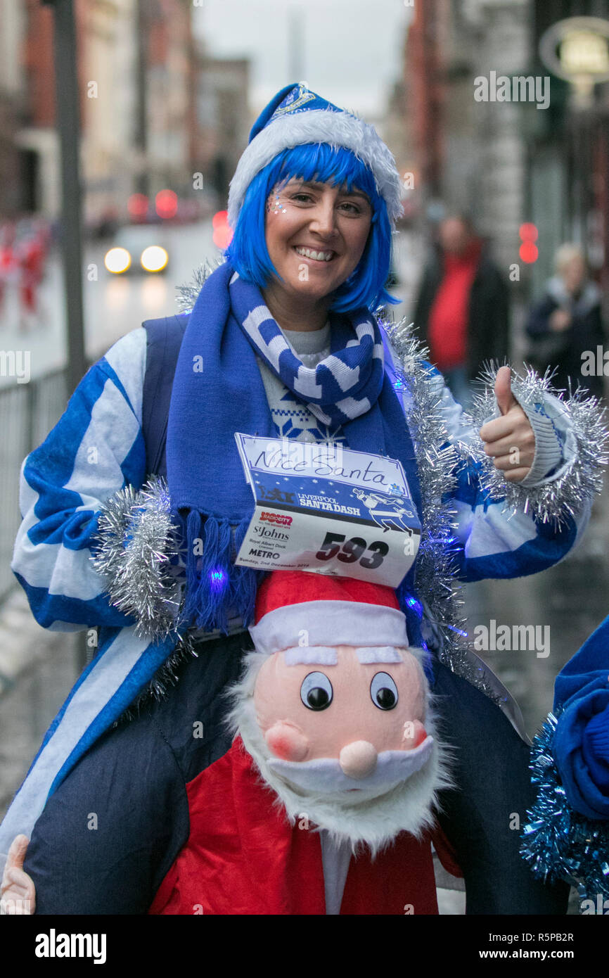 Liverpool, Merseyside, UK.  2nd November, 2018. BTR Liverpool Santa Dash.  People across Merseyside celebrate the  return of the UK’s biggest festive 5K fun run. The festive event has  continued to grow  with up to 10,000 runners, red, blue and mini Santas taking part this year.  The route took the Dashing Evertonian Santas through the city centre, before they crossed the finish line outside Town Hall, where they were greeted by myriad of festive characters. Credit:MediaWorldImages/AlamyLiveNews. Stock Photo