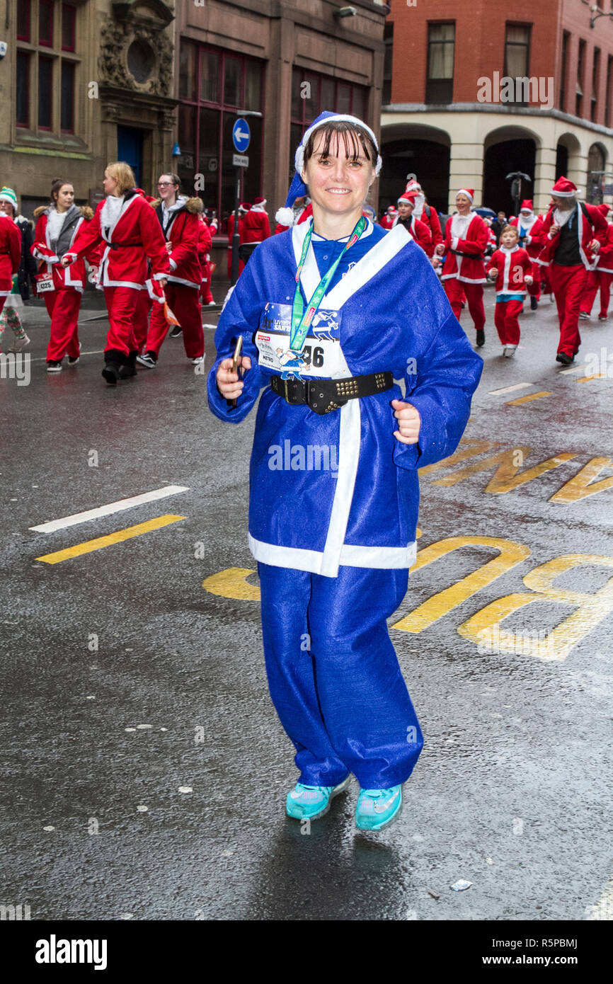 Liverpool, Merseyside, UK. 2nd December 2018. BTR Liverpool Santa Dash. People across Merseyside celebrate the  return of the UK’s biggest festive 5K fun run. The festive event has  continued to grow  with up to 10,000 runners, red, blue and mini Santas taking part this year.  The route took the Dashing Santas through the city centre, before they crossed the finish line outside Town Hall, where they were greeted by myriad of festive characters. Credit: Cernan Elias/AlamyLiveNews. Stock Photo