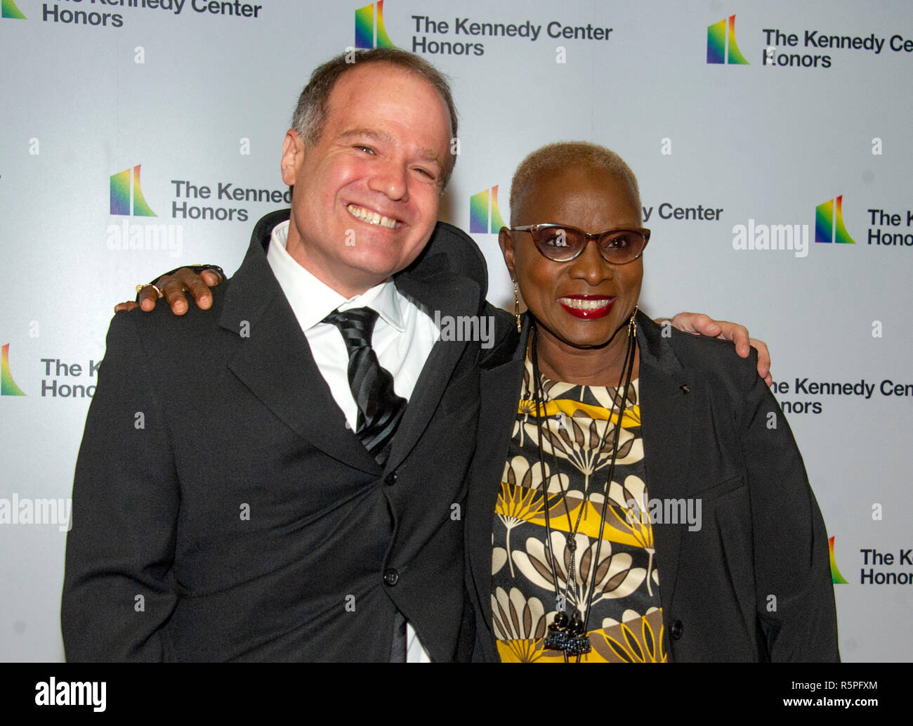 Washington, USA. 1st Dec 2018. Singer Angelique Kidjo, right, and Kevin Morris arrive for the formal Artist's Dinner honoring the recipients of the 41st Annual Kennedy Center Honors hosted by United States Deputy Secretary of State John J. Sullivan at the US Department of State in Washington, DC on Saturday, December 1, 2018.  he co-creators of Hamilton, writer and actor Lin-Manuel Miranda, director Thomas Kail, choreographer Andy Blankenbue Credit: MediaPunch Inc/Alamy Live News Stock Photo