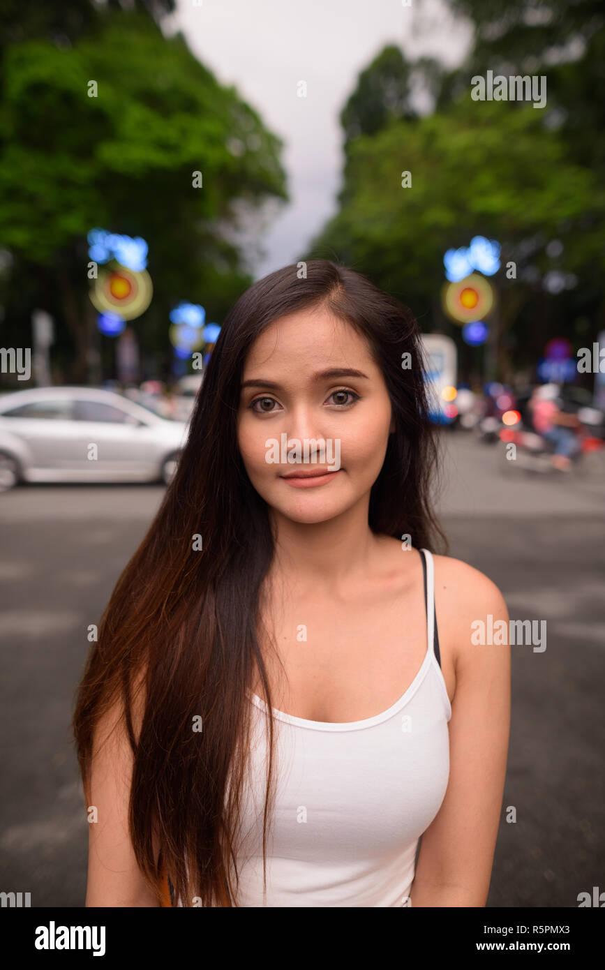 Young beautiful Asian tourist woman exploring Ho Chi Minh city i Stock Photo