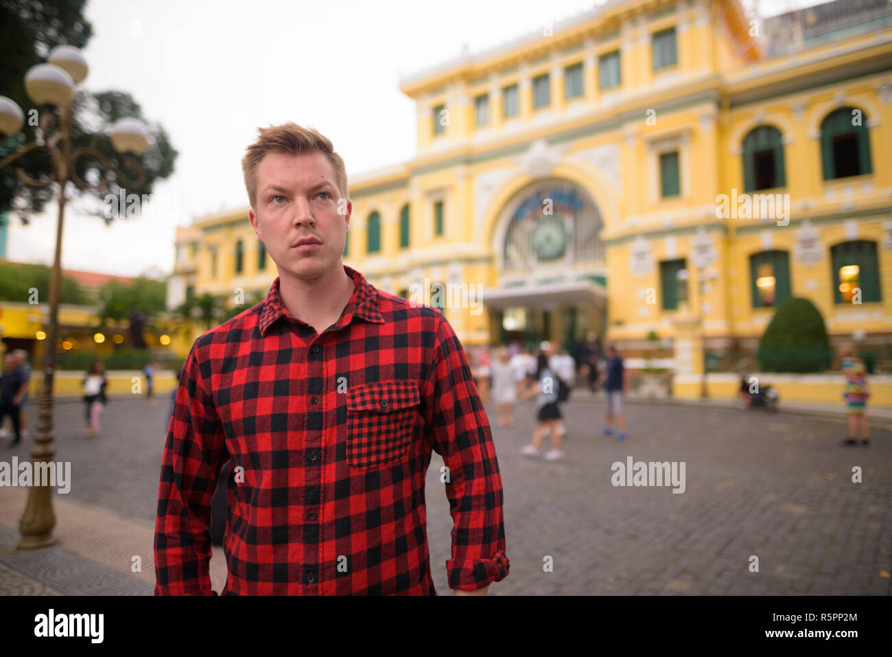 Tourist man in front of Saigon Central Post Office Stock Photo