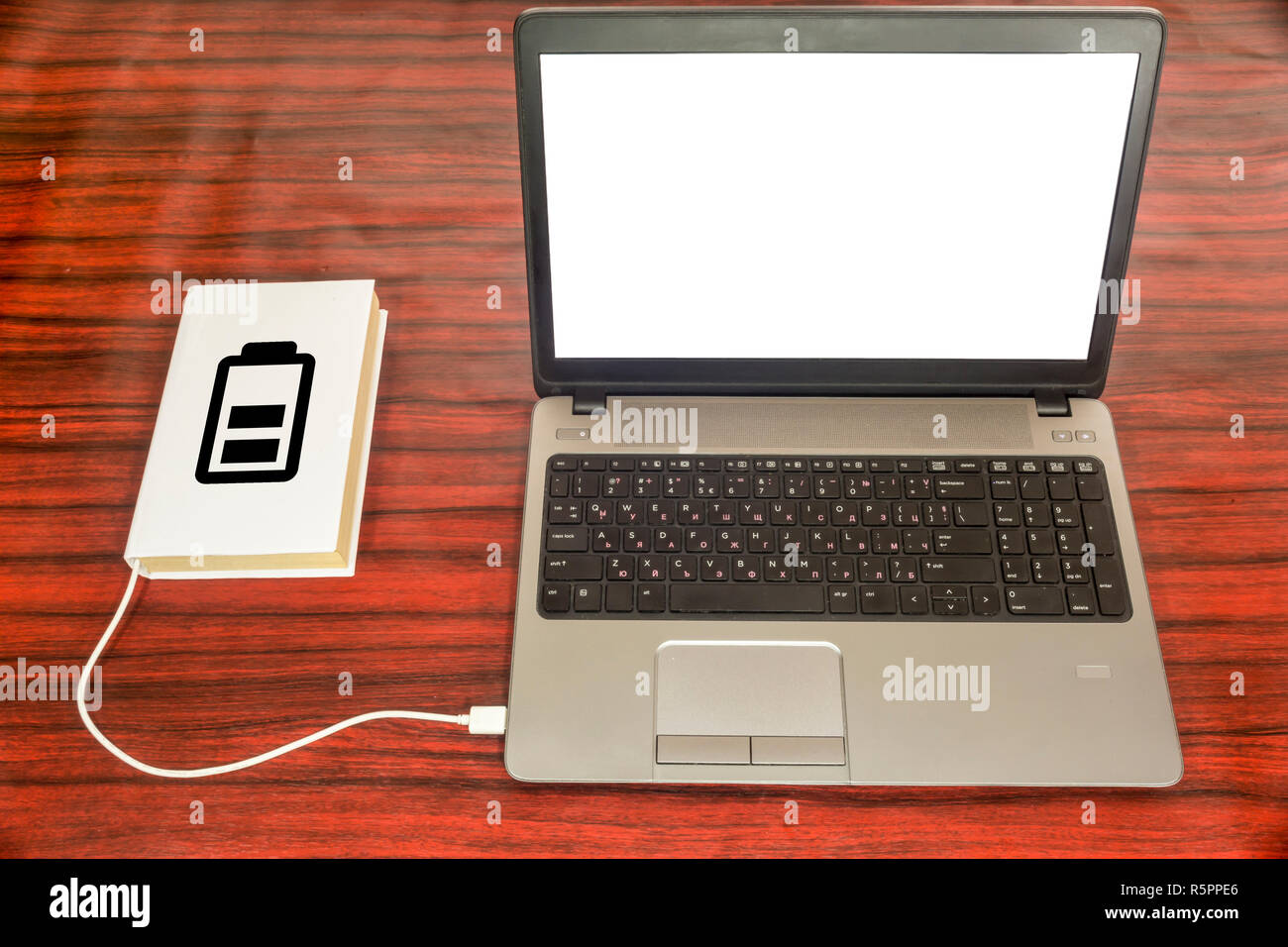 connected to a laptop through a USB charger. Battery symbol indicating the charge level Stock Photo - Alamy