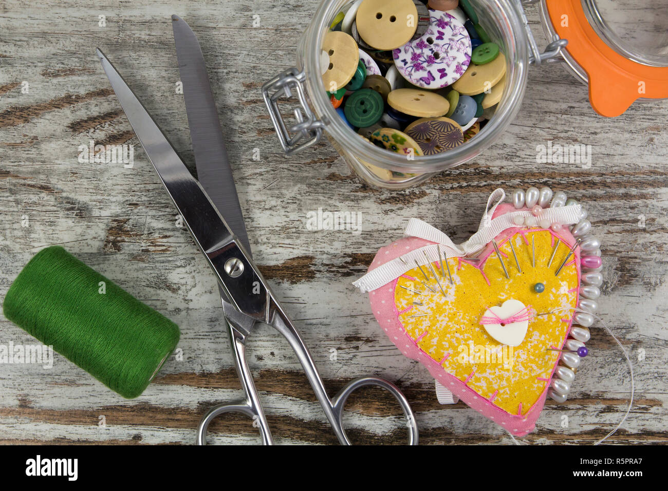 Sewing tools in a wooden background, vintage Stock Photo