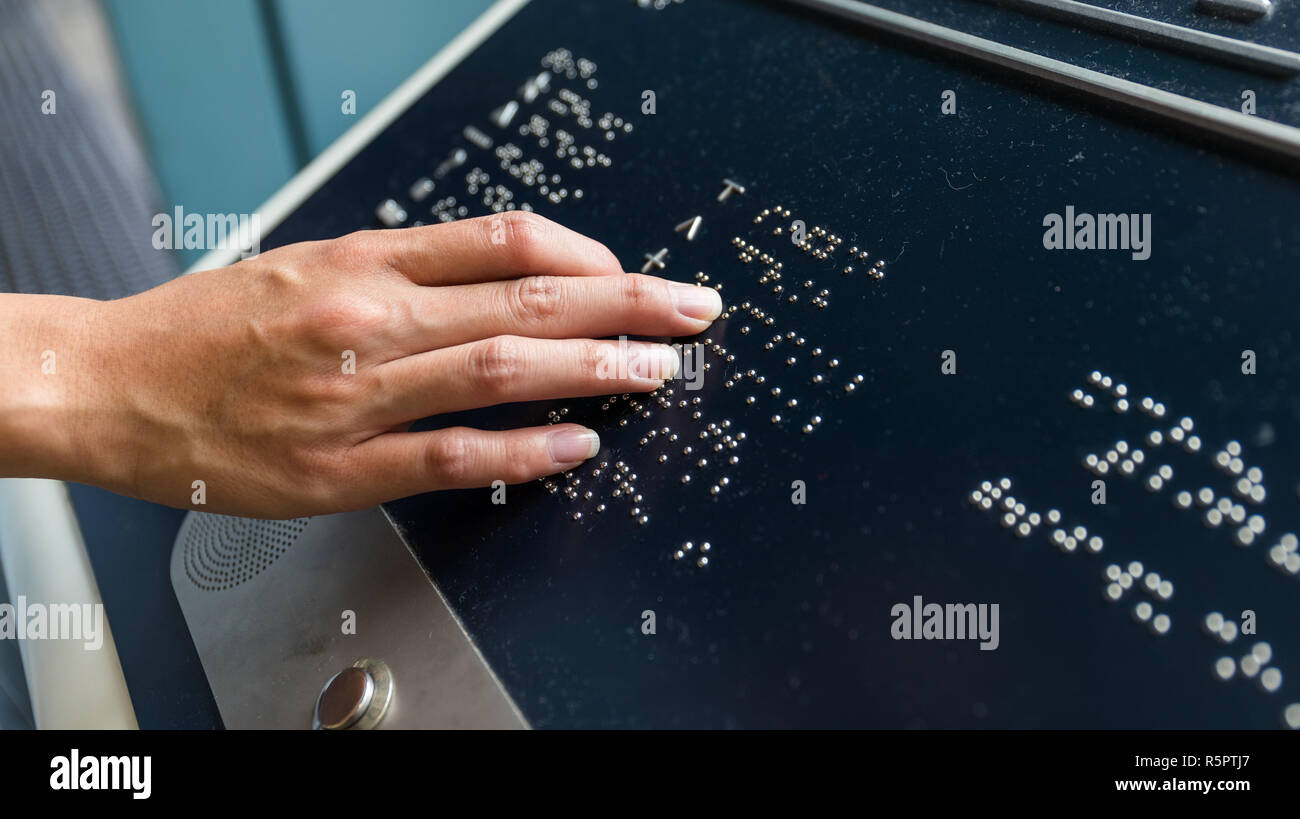 Hand touch on braille text panel Stock Photo