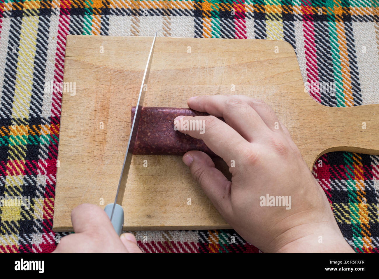 Cutting Traditional Bulgarian Flat Sausage Called Lukanka First Person cutting-traditional-bulgarian-flat-sausage-called-lukanka-first-person