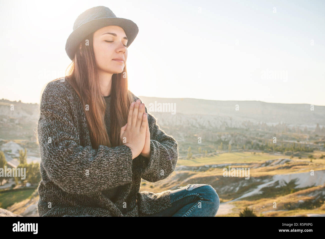 A girl practices yoga or meditation or searching for a soul. Solitude and unplugged Stock Photo