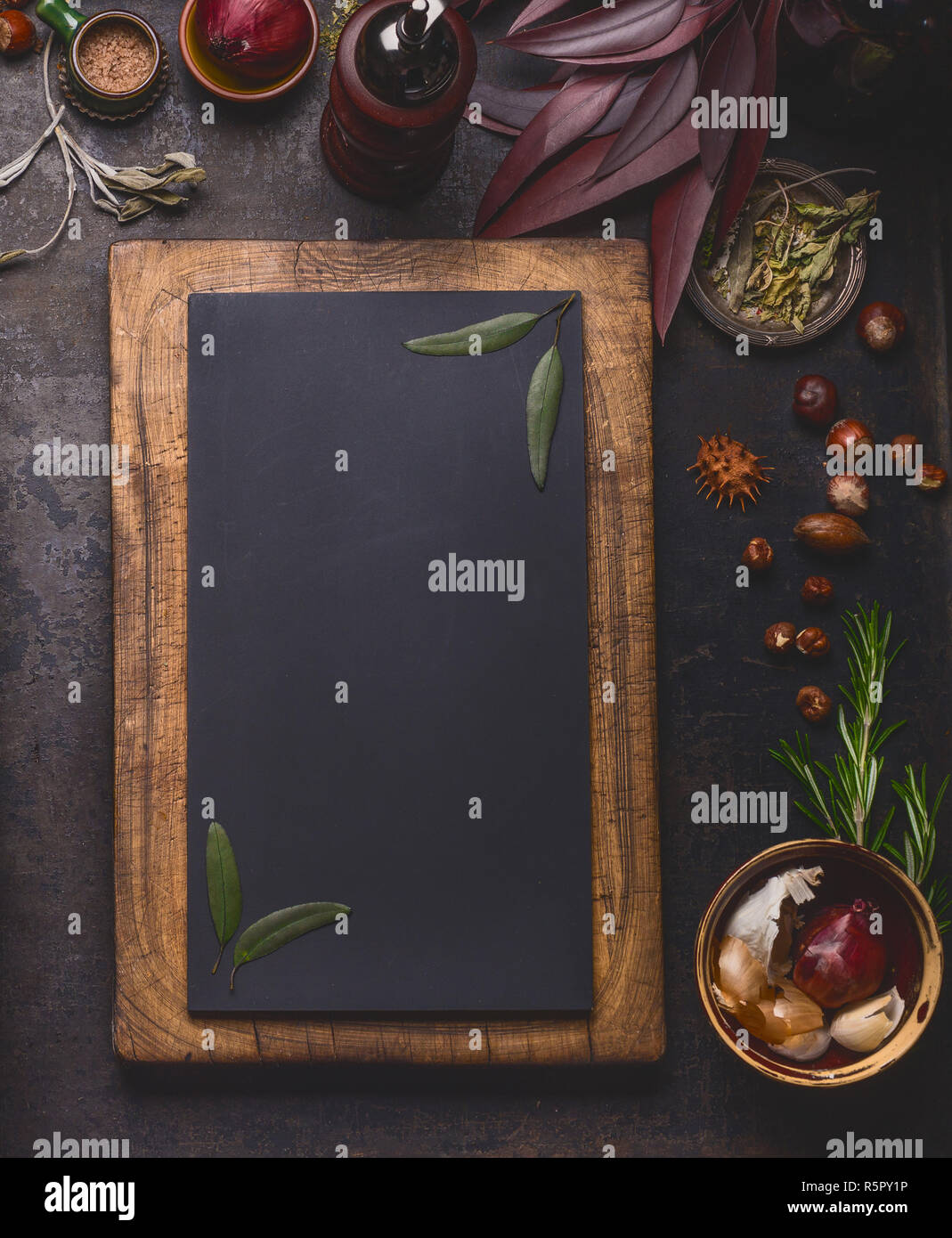 Blank chalkboard in wooden frame and cooking ingredients on dark kitchen table background, top view, frame . Stock Photo
