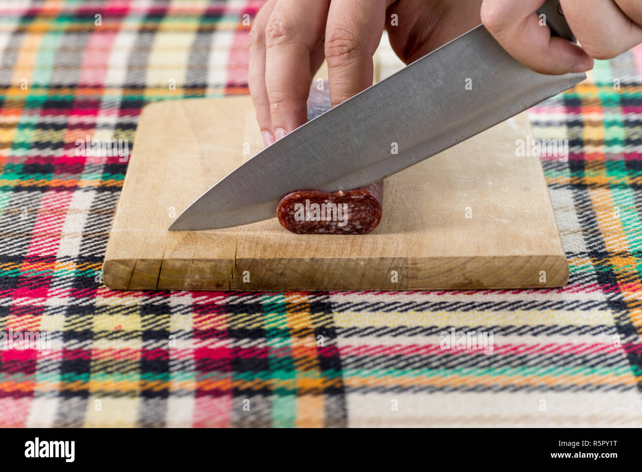 Cutting Traditional Bulgarian Flat Sausage Called Lukanka Stock Photo cutting-traditional-bulgarian-flat-sausage-called-lukanka-stock-photo