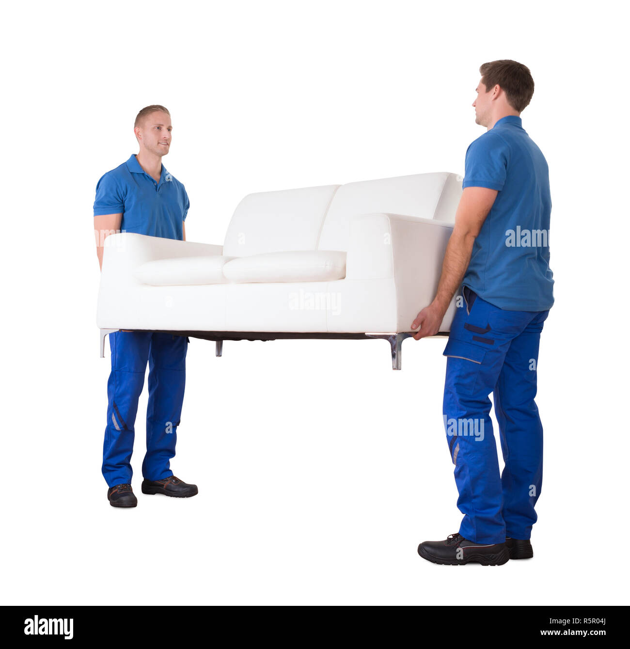 Young Movers Moving Sofa In New Home Stock Photo Alamy