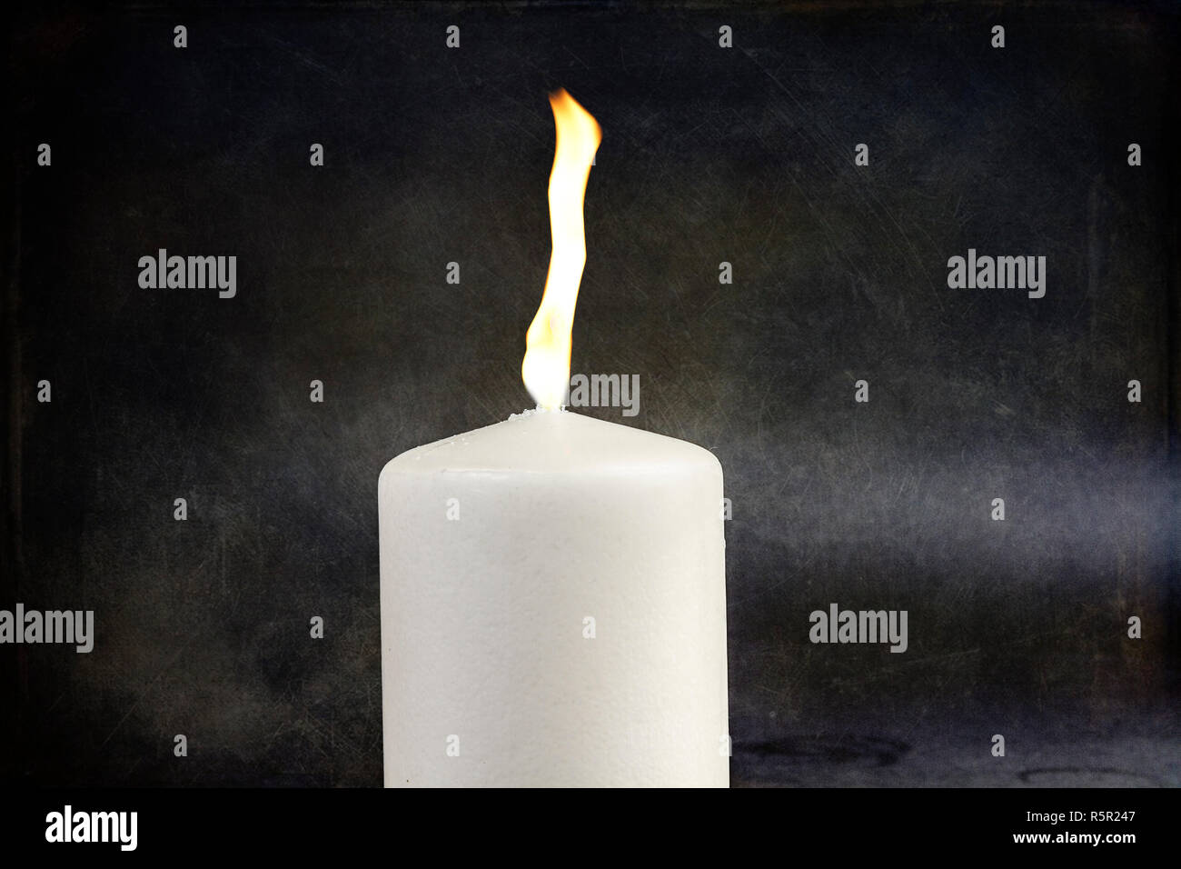 Flaming candle Stock Photo
