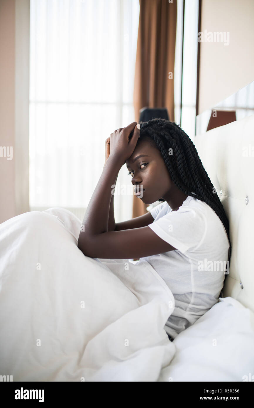 Headache, Depression, Restless Afro-American Woman Sleeping on Side Awaking from Sleep Stock Photo