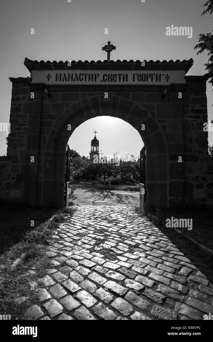 Entrance stone gate to the Monastery of St. George in Pomorie. Bulgaria. Black and white. Stock Photo