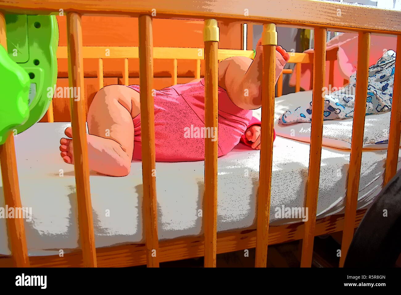 Baby, infant feet sticking out through the rails of a crib, cot
