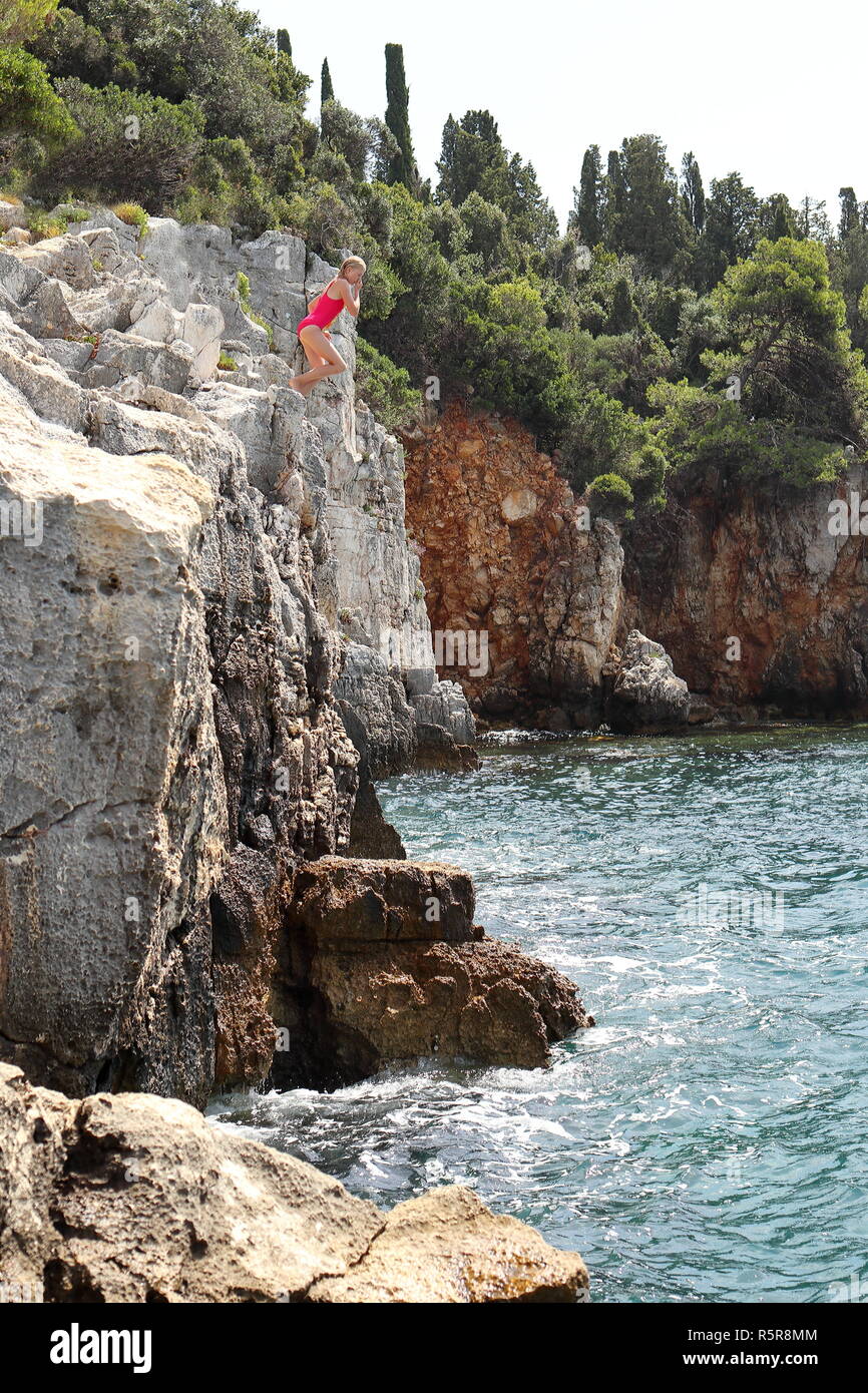 girl jumping from rock lip Stock Photo Alamy
