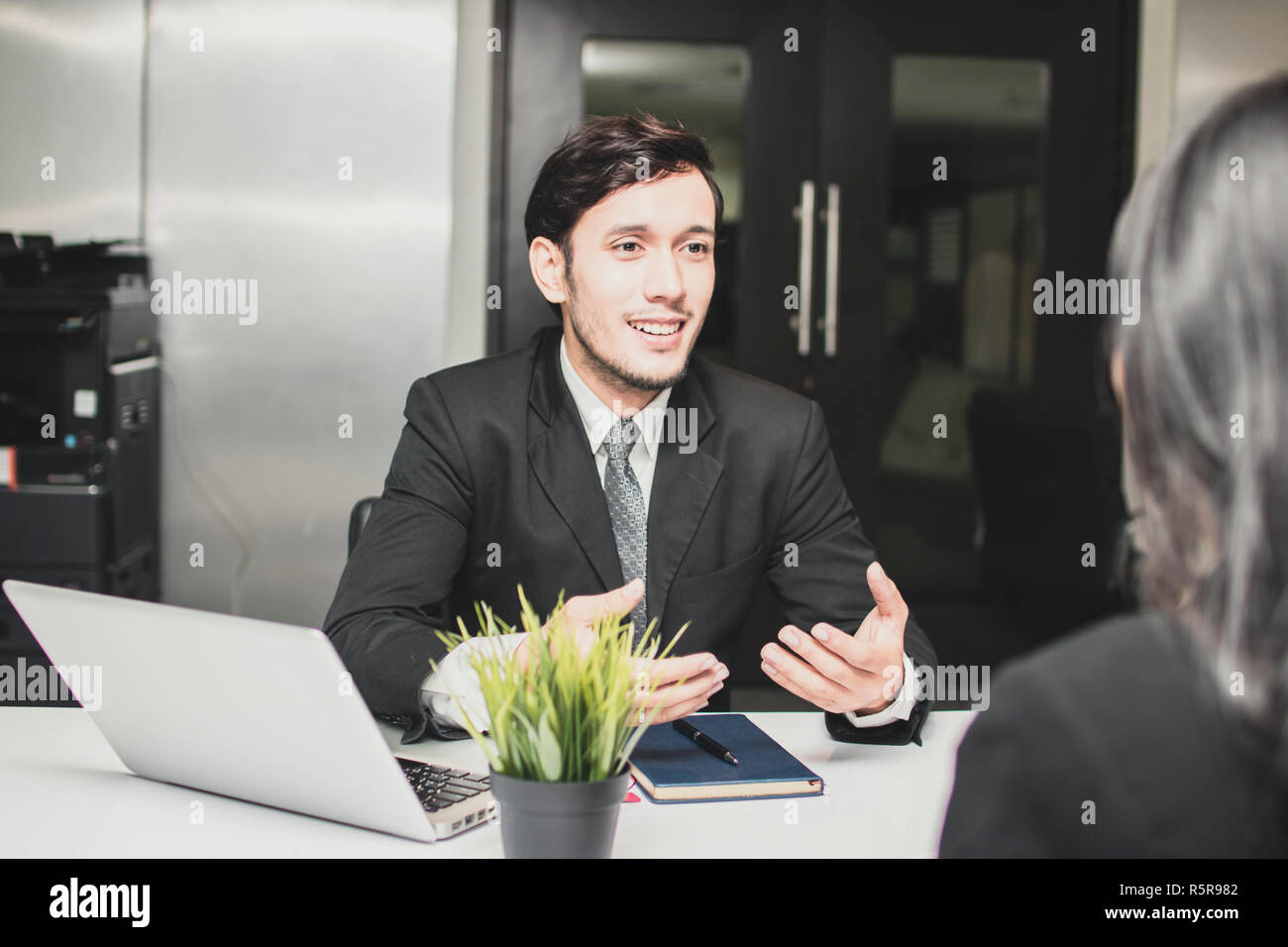 Smiled and happy manager businessman explaining, introducing and talking with businesswomen about new project. Stock Photo