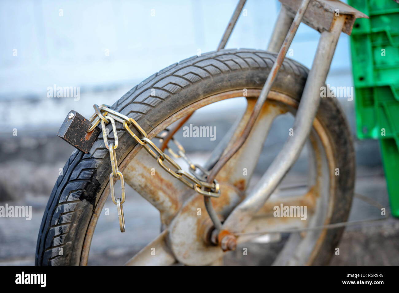 Closeup photography. An old motorcycle front wheel is locked in the