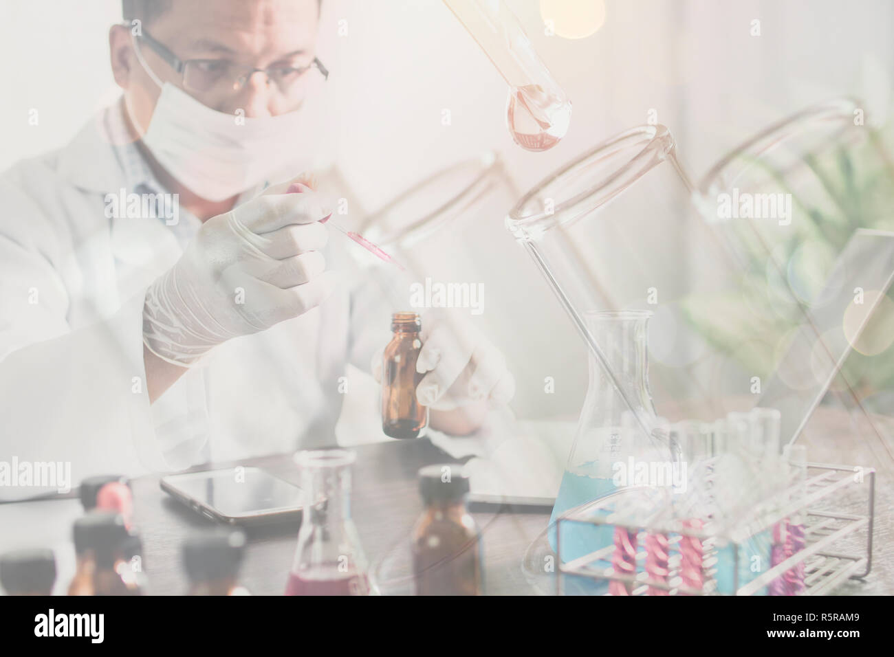 Experimental scientist holding science tube in lab Stock Photo Alamy