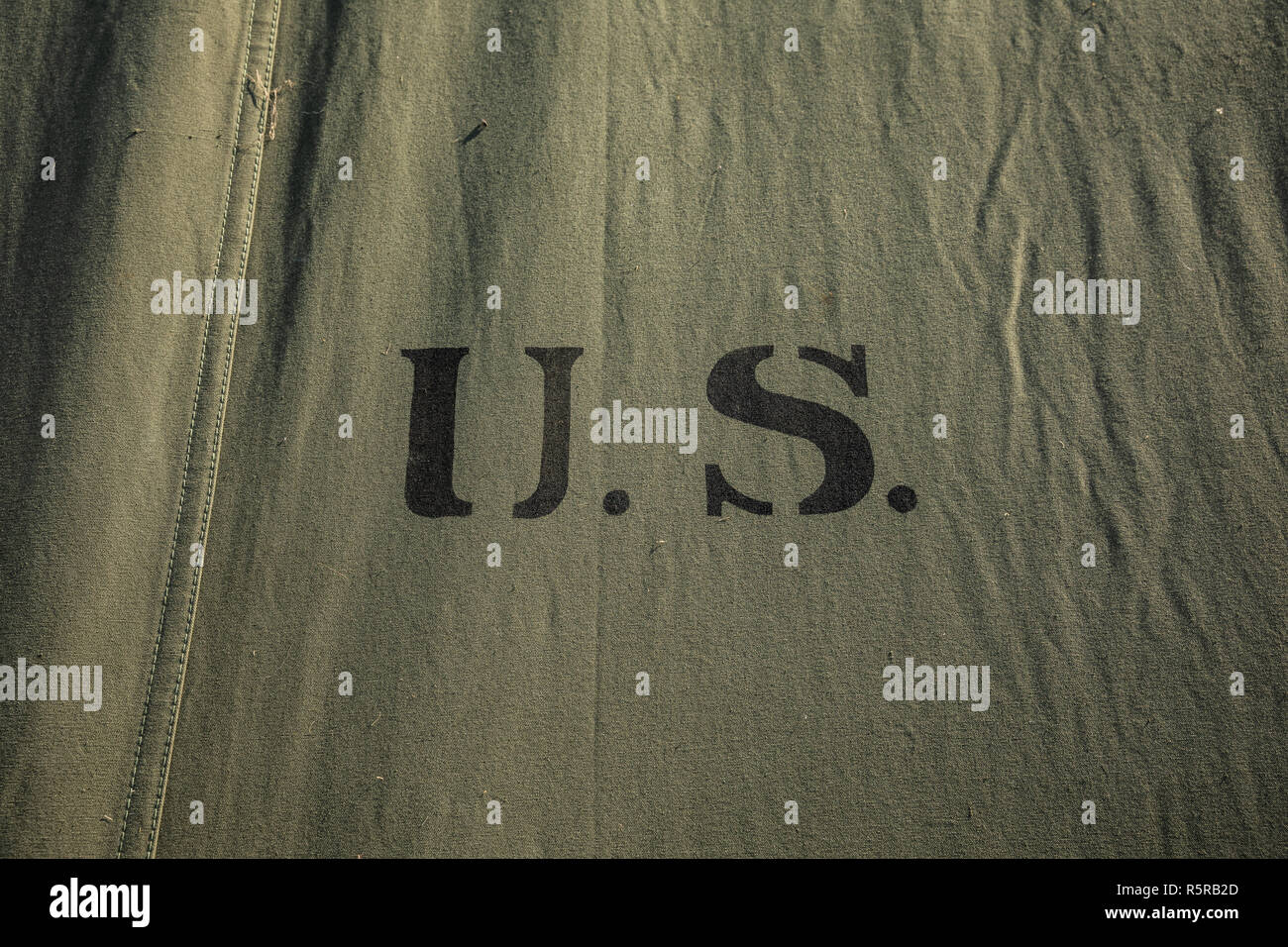 Green military tent fabric with U.S. initials Stock Photo