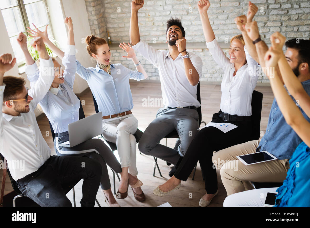 Business, startup, gesture, people and teamwork concept - happy creative team in office Stock Photo