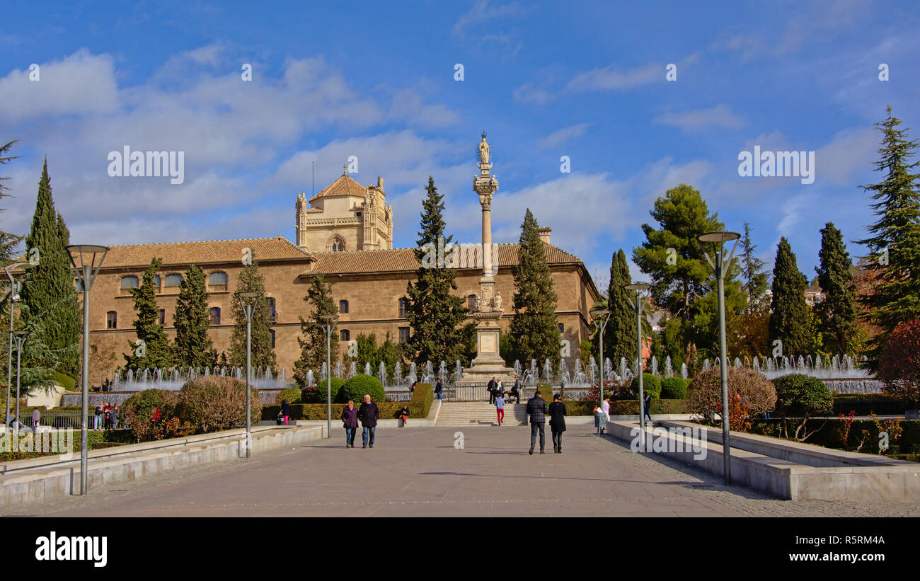 Plaza del Triunfo square with monument of Mary Immaculate conception on a high pedestal and the Royal Hospital of Granada, Andalusia, Spain Stock Photo