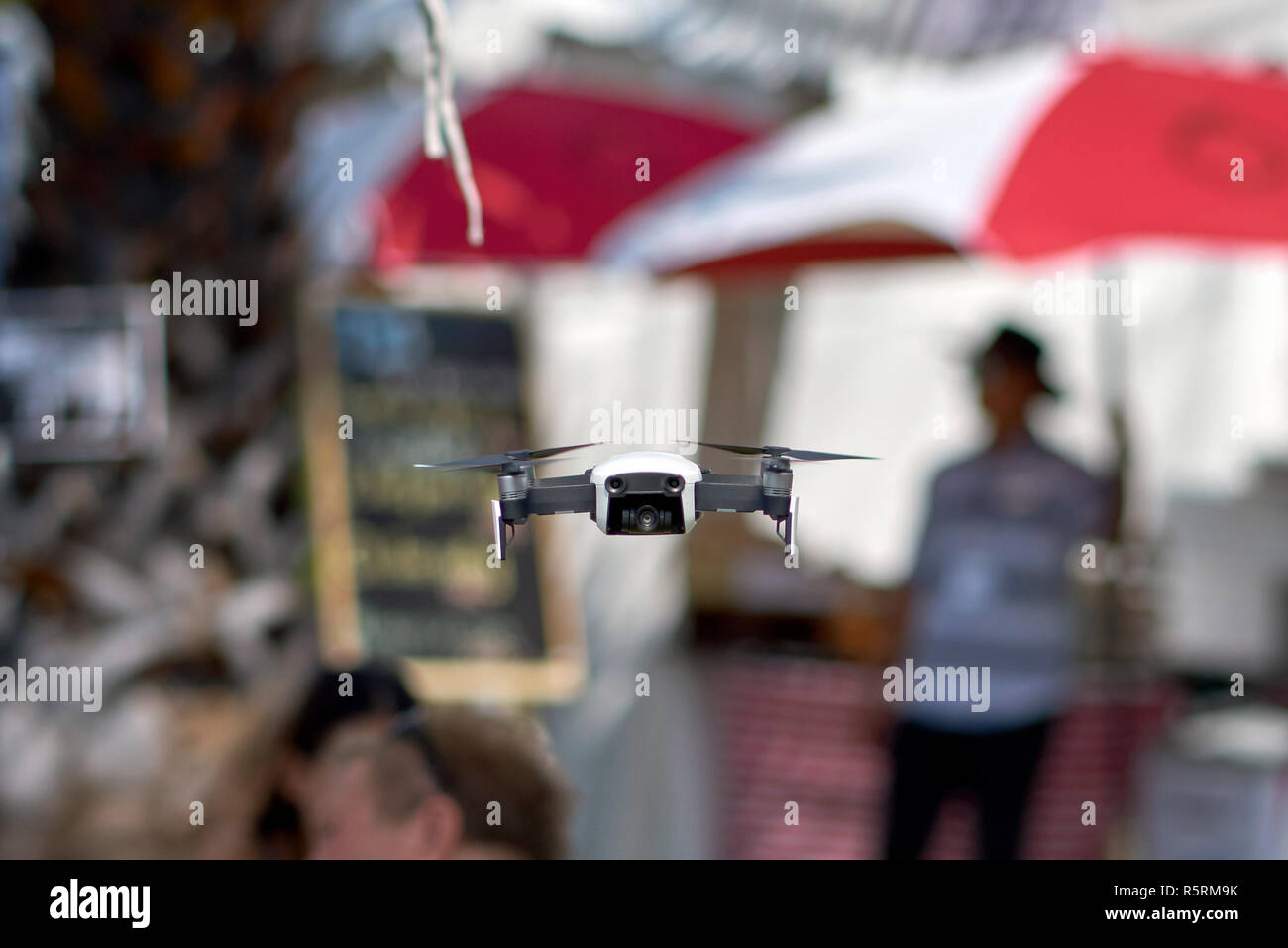 DJI Mavic Air drone flying low amongst the crowd at a demonstration Stock Photo