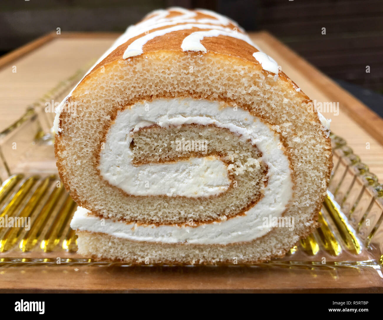 sponge roll with filling on a glass plate Stock Photo