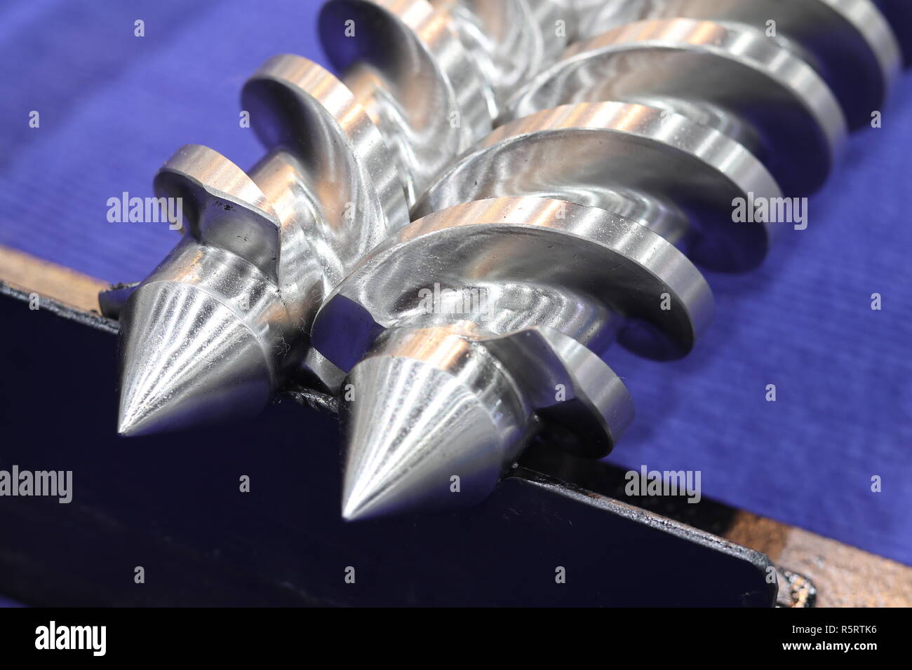 Screw press parts for plastic injection machine ; selective focus Stock Photo