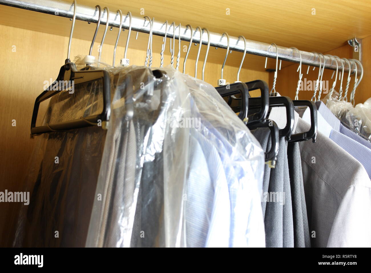 Dirty wardrobe with various men's clothes Stock Photo