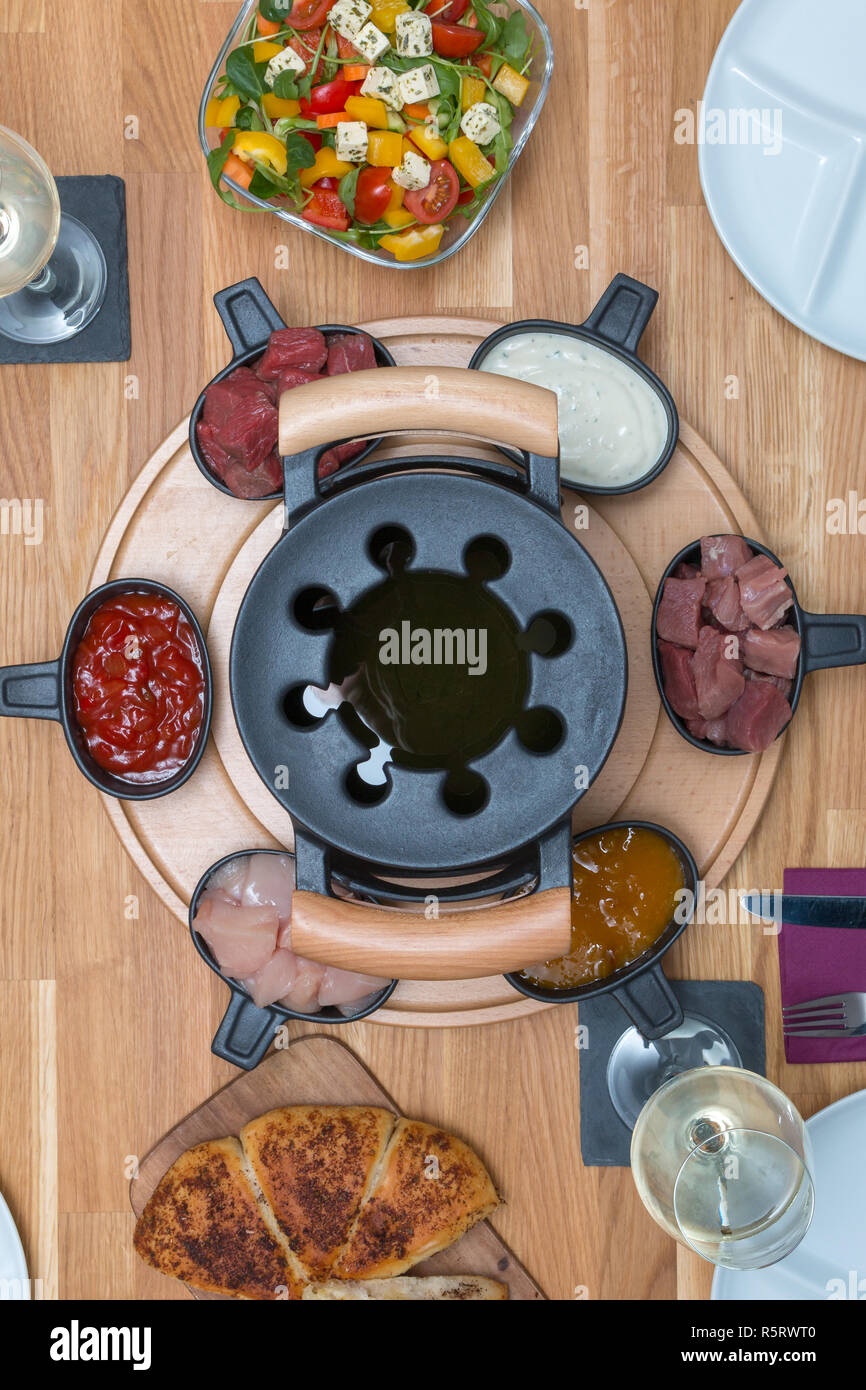 Traditional fondue with different meats and side dishes Stock Photo Alamy