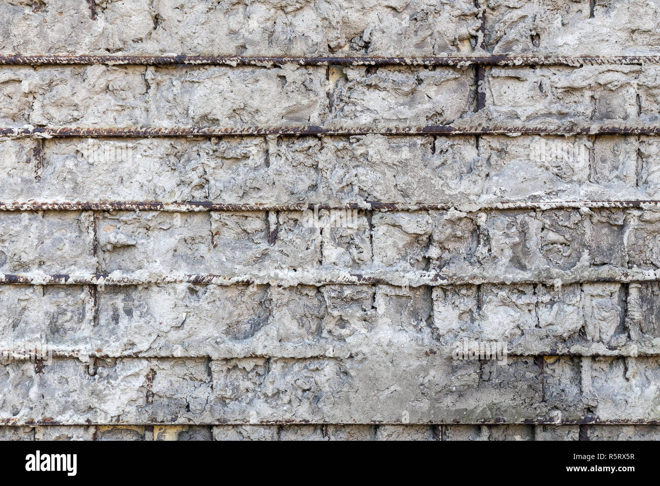 Fragment of a gray concrete wall with metal structures Stock Photo - Alamy