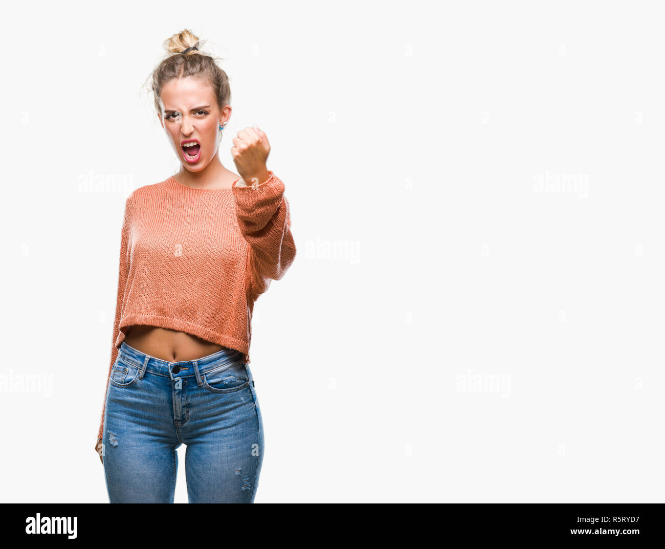 Beautiful young blonde woman over isolated background angry and mad ...