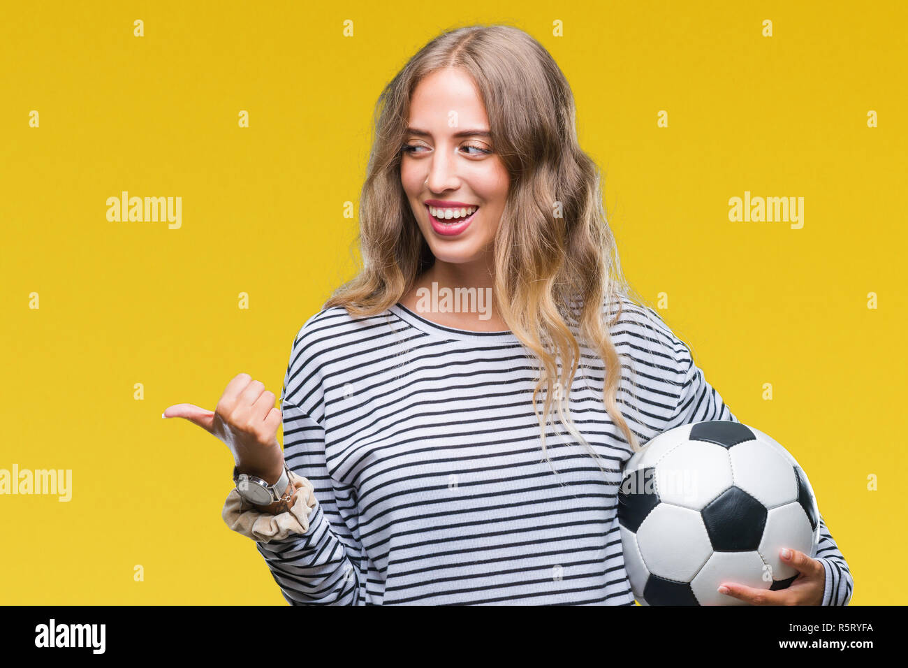 Premium Photo  Athletic blonde posing as american football girl on black  background. beautiful young woman wearing american football top holding  ball. studio photo of american football woman