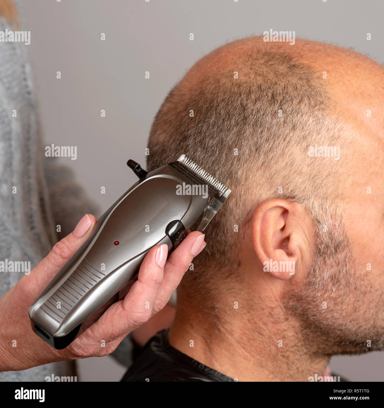 cutting hair with electric clippers