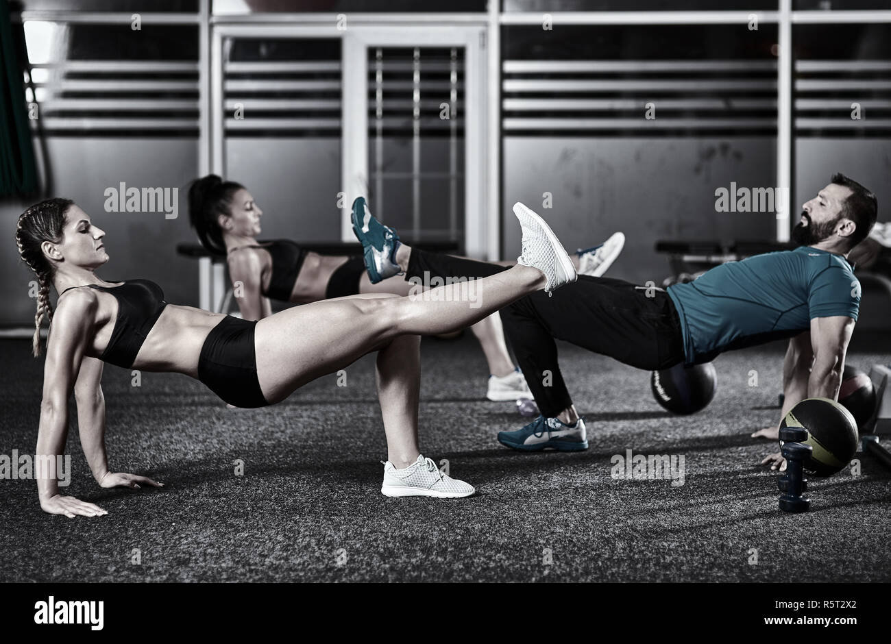 Fitness trainer and girls doing workout in the gym Stock Photo - Alamy
