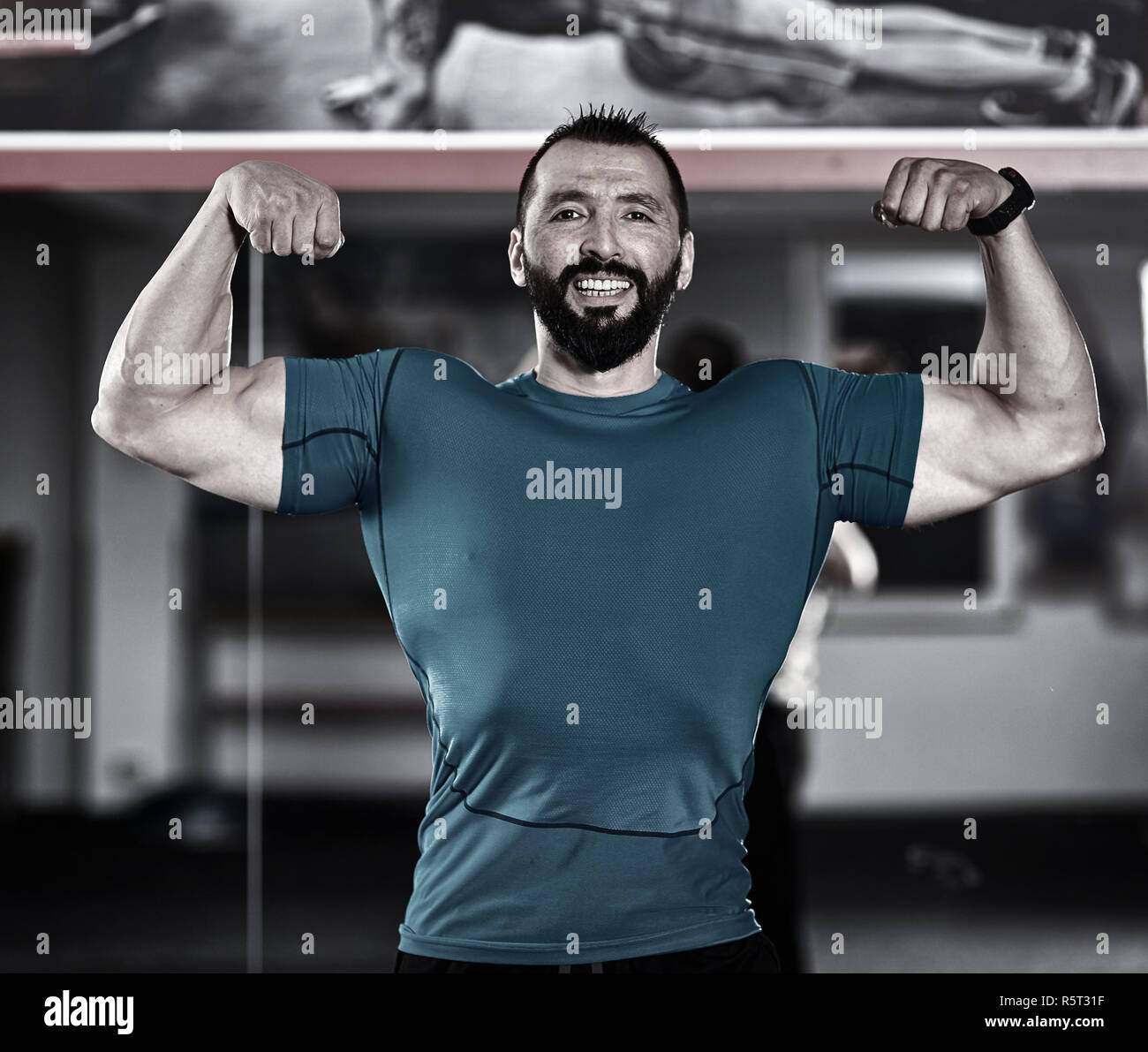 Fitness trainer posing in a gym, showing off muscles Stock Photo Alamy