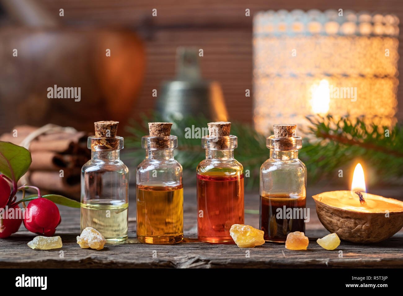 Christmas collection of essential oils with frankincense, wintergreen and candles Stock Photo