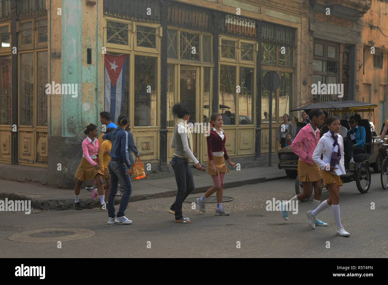 Cuba: schoolkids crossing a street in Havanna city Stock Photo