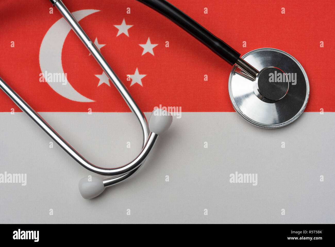 Singapore flag and stethoscope. The concept of medicine. Stethoscope on