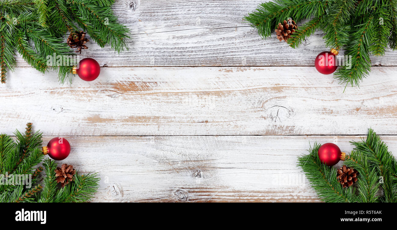 Christmas Evergreen branches and red ball decorations in all corners on ...