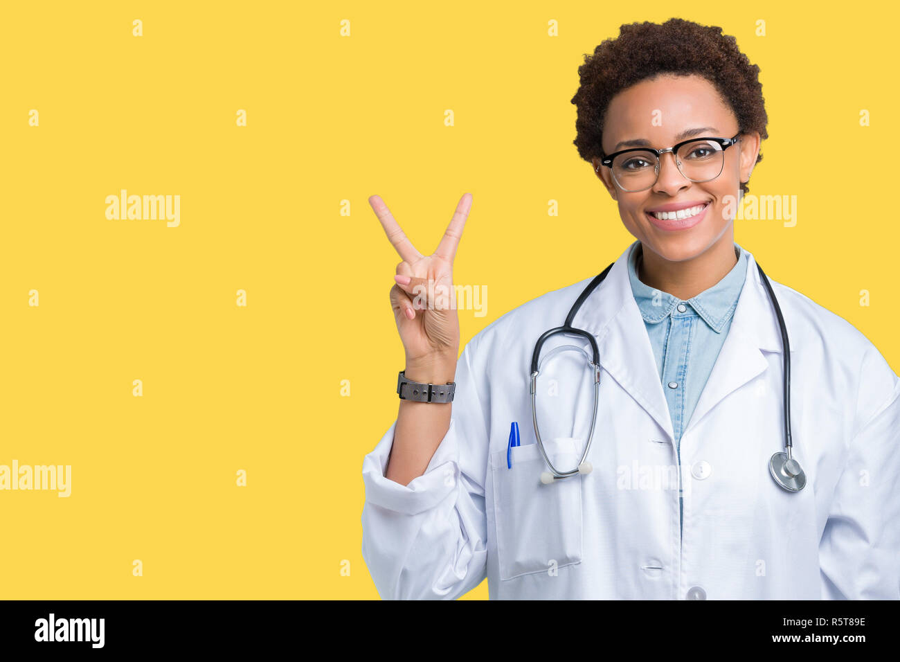 Young african american doctor woman wearing medical coat over isolated ...