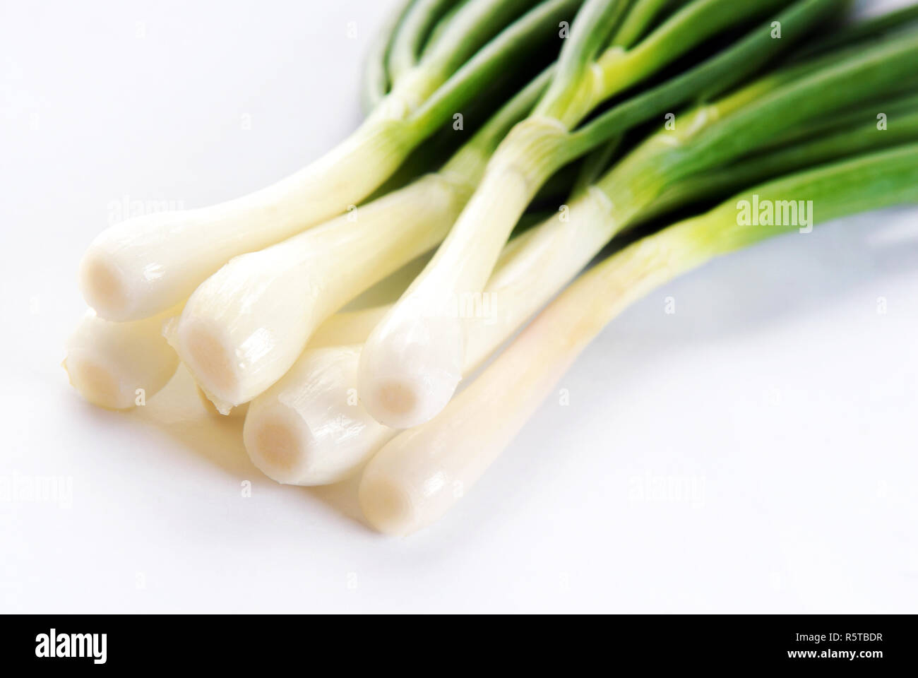 Onions bunch on a white background Stock Photo - Alamy
