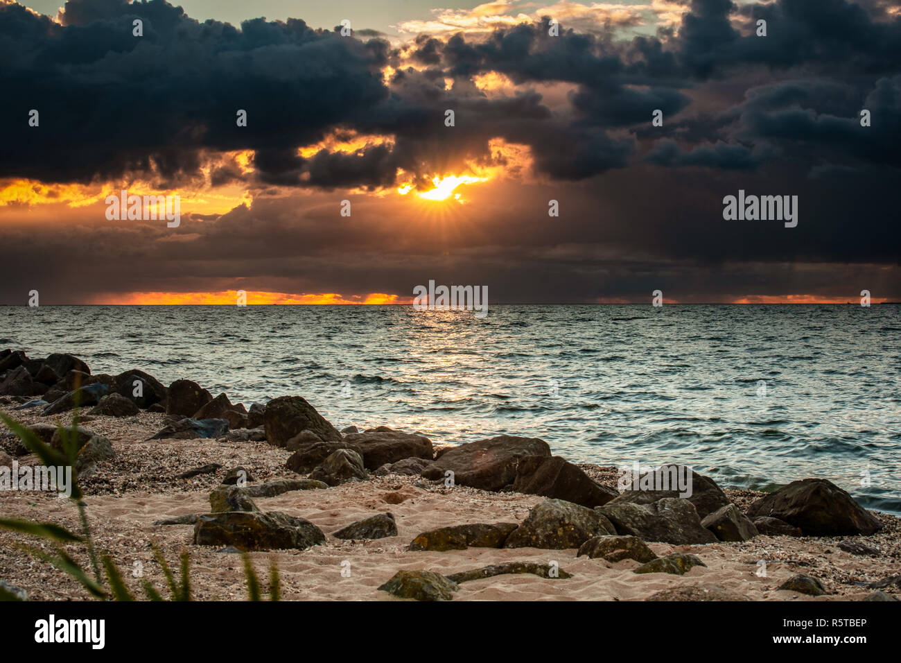 Beautiful view from the beach with shells, and large rocks along the Ijsselmeer near Urk in Flevoland Stock Photo