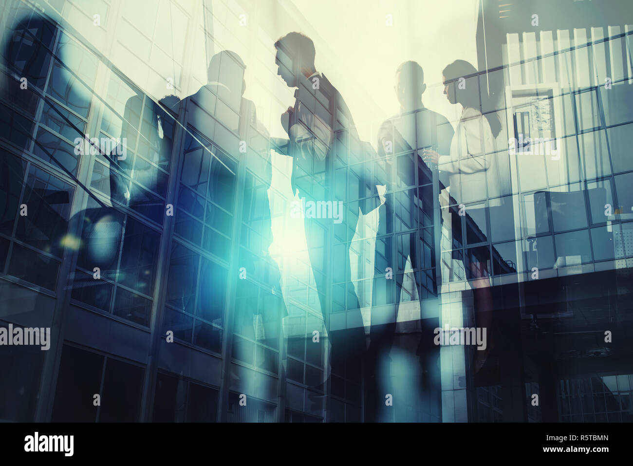 Silhouette of business people working together in office. Concept of teamwork and partnership. double exposure with light effects Stock Photo