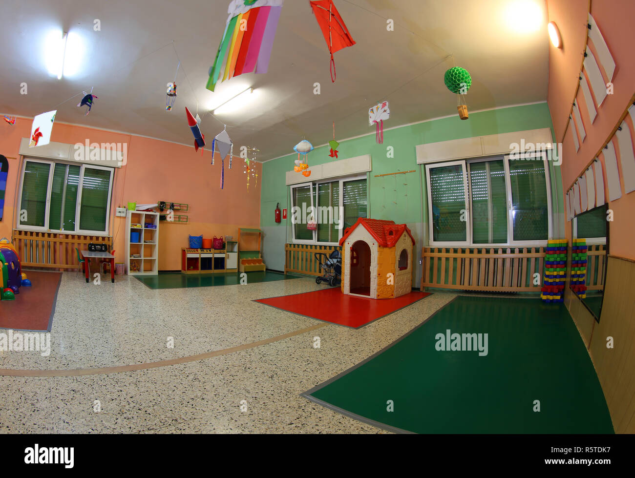 wide hall of a kindergarten with many toys and whitout children Stock Photo