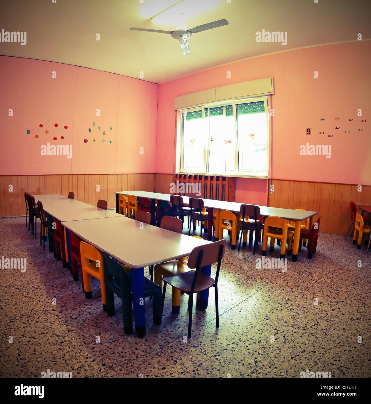 inside a school classroom of a nursery school without children with vintage old effect Stock Photo